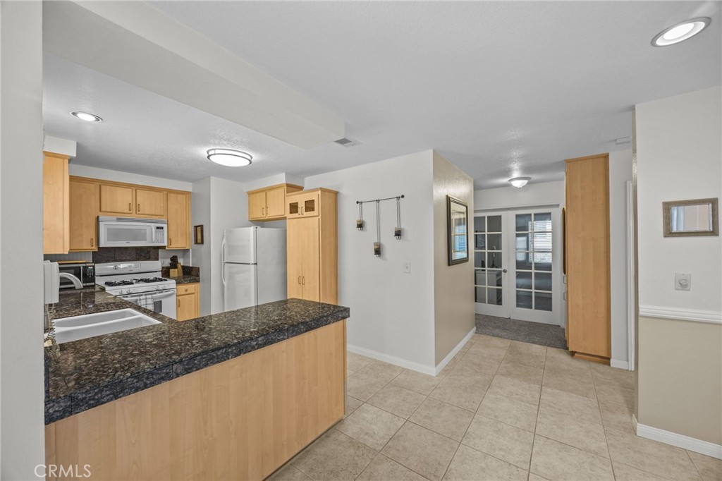 1763 Gleason Street Corona, CA 92882 - Photo 18 of 41 a kitchen with stainless steel appliances granite countertop a refrigerator and a sink