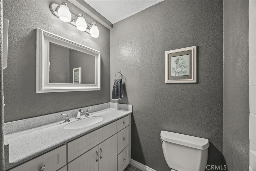 1763 Gleason Street Corona, CA 92882 - Photo 30 of 41 a bathroom with a toilet a sink and mirror