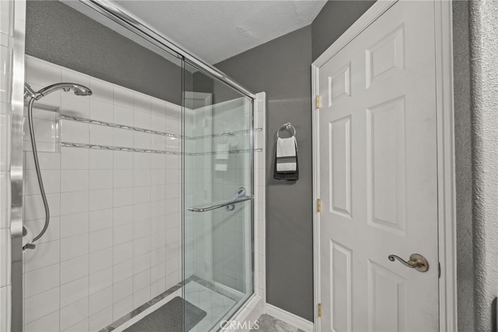 1763 Gleason Street Corona, CA 92882 - Photo 31 of 41 a bathroom with a glass door shower