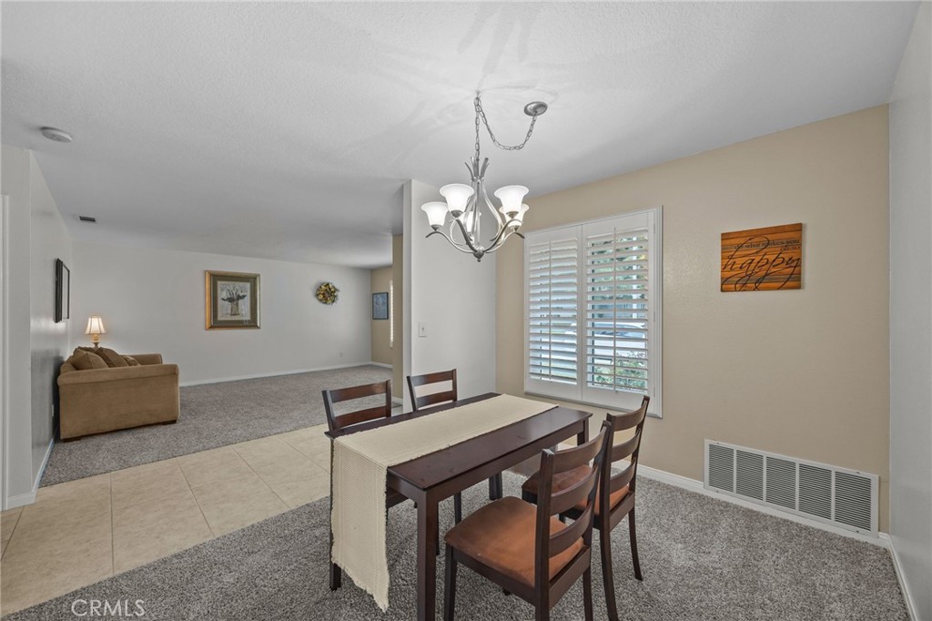 1763 Gleason Street Corona, CA 92882 - Photo 9 of 41 a dining room with a wooden table and chairs