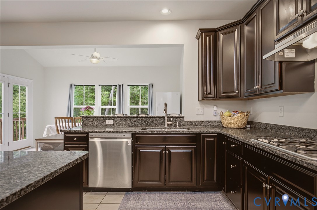 9013 Bailey Hill Road Midlothian, VA 23112 - Photo 21 of 56 Kitchen featuring dark wood cabinetry, speckled co