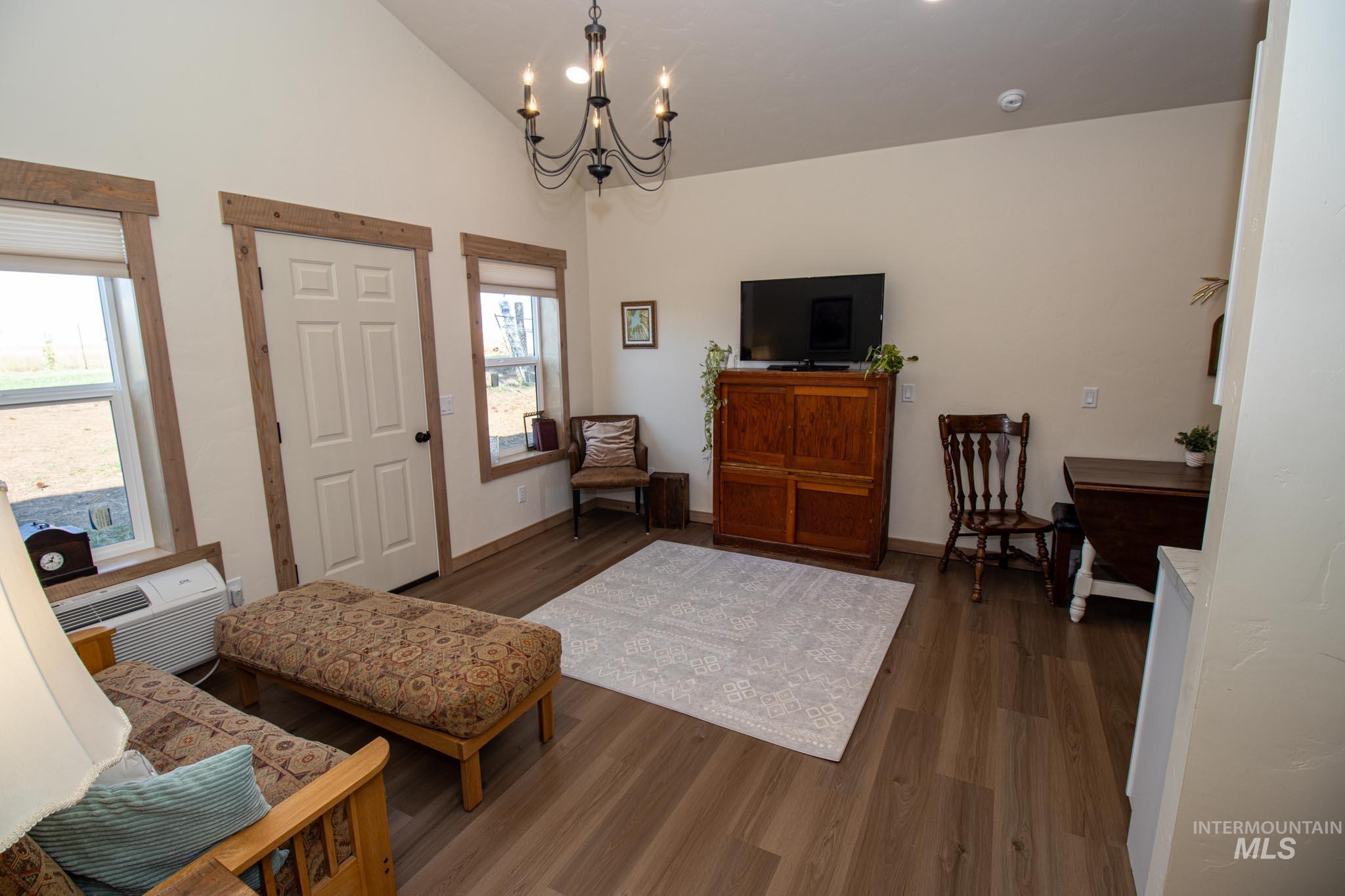 263 Glory Lane Orofino, ID 83544 - Photo 31 of 48 Living room with hanging lights, dark wood-type flooring, and vaulted ceiling