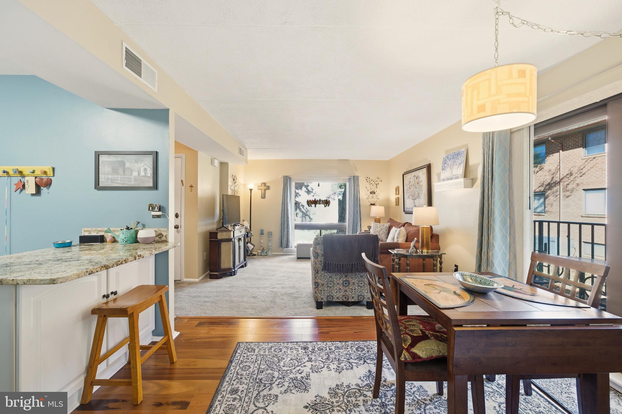 844 Putnam Boulevard, Unit 61A Wallingford, PA 19086 - Photo 11 of 23 a living room with stainless steel appliances granite countertop furniture and a dining table