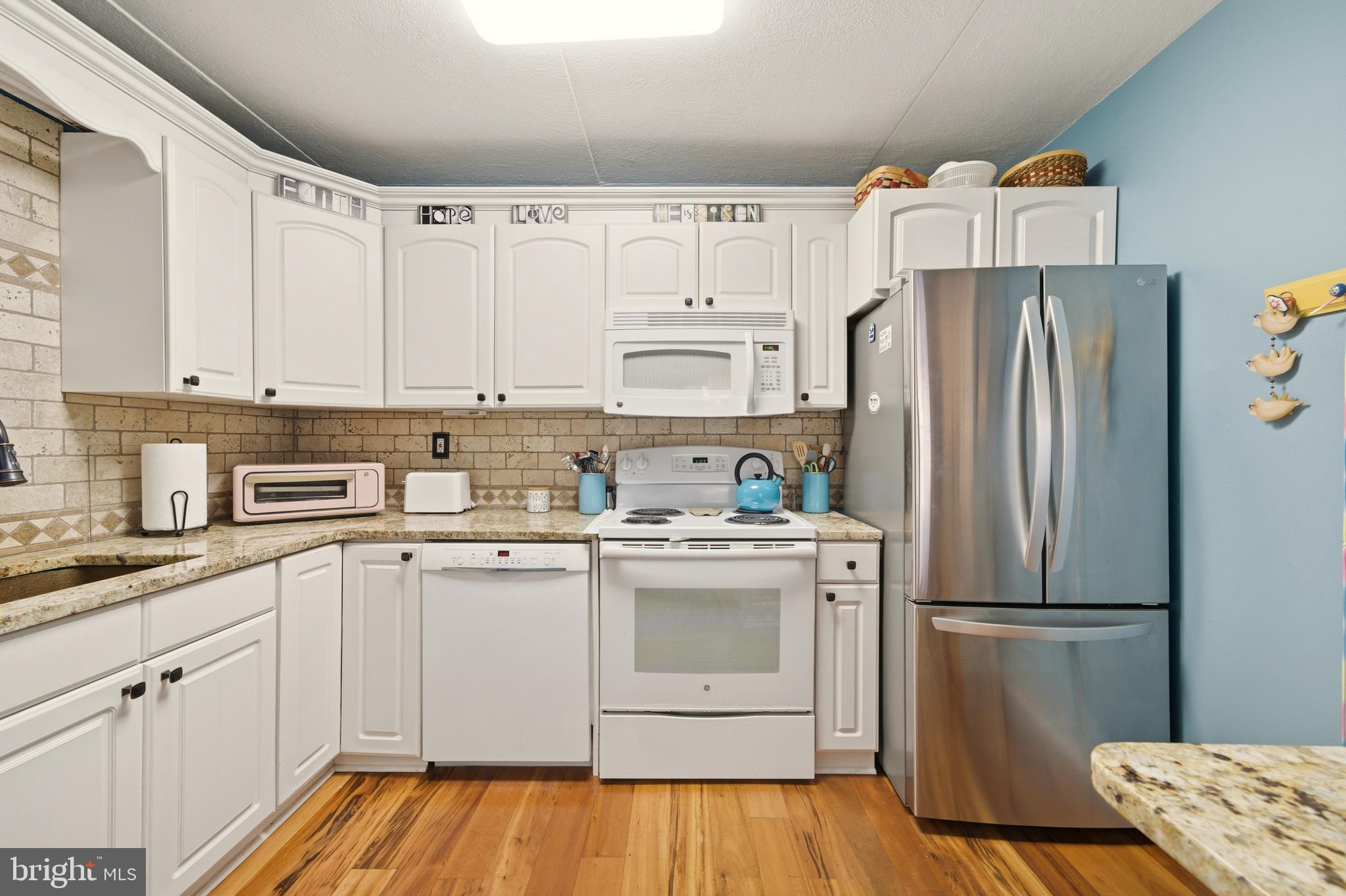 844 Putnam Boulevard, Unit 61A Wallingford, PA 19086 - Photo 14 of 23 a kitchen with a white cabinets and stainless steel appliances
