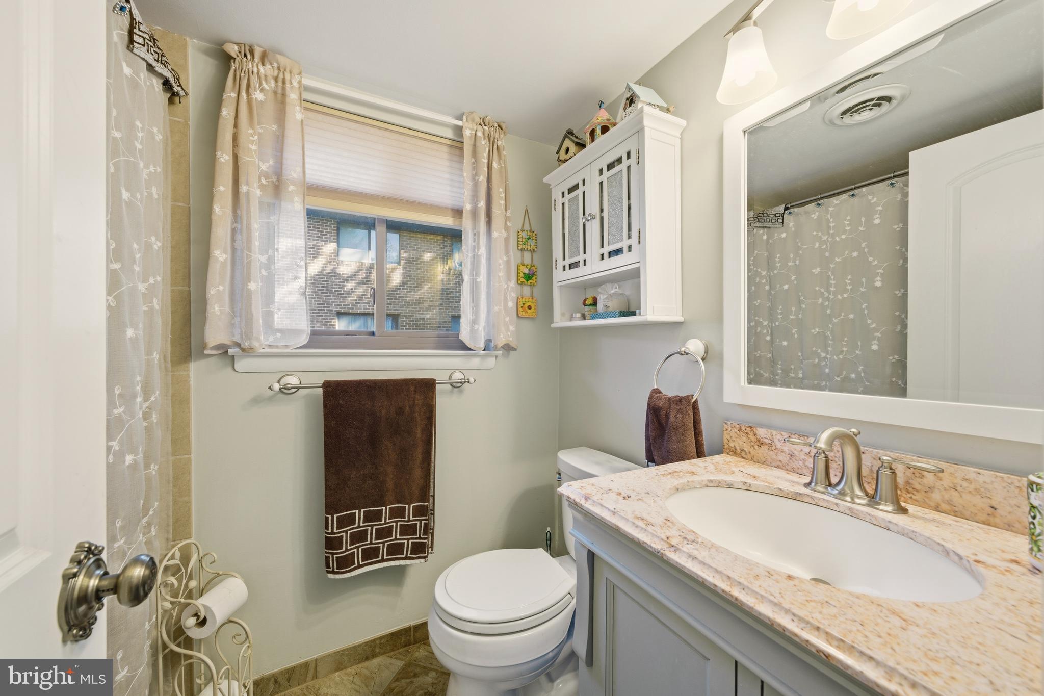 844 Putnam Boulevard, Unit 61A Wallingford, PA 19086 - Photo 16 of 23 a bathroom with a granite countertop sink toilet and shower