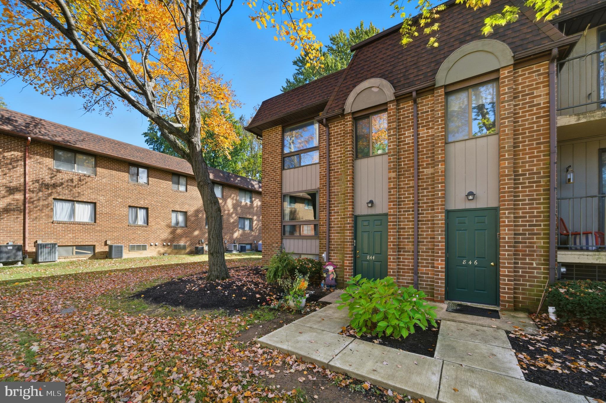 844 Putnam Boulevard, Unit 61A Wallingford, PA 19086 - Photo 2 of 23 a front view of a house with garden