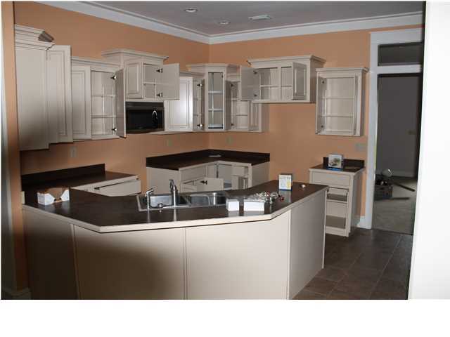 370 Mallet Bayou Road Freeport, FL 32439 - Photo 5 of 12 a kitchen with stainless steel appliances kitchen island granite countertop a sink and cabinets