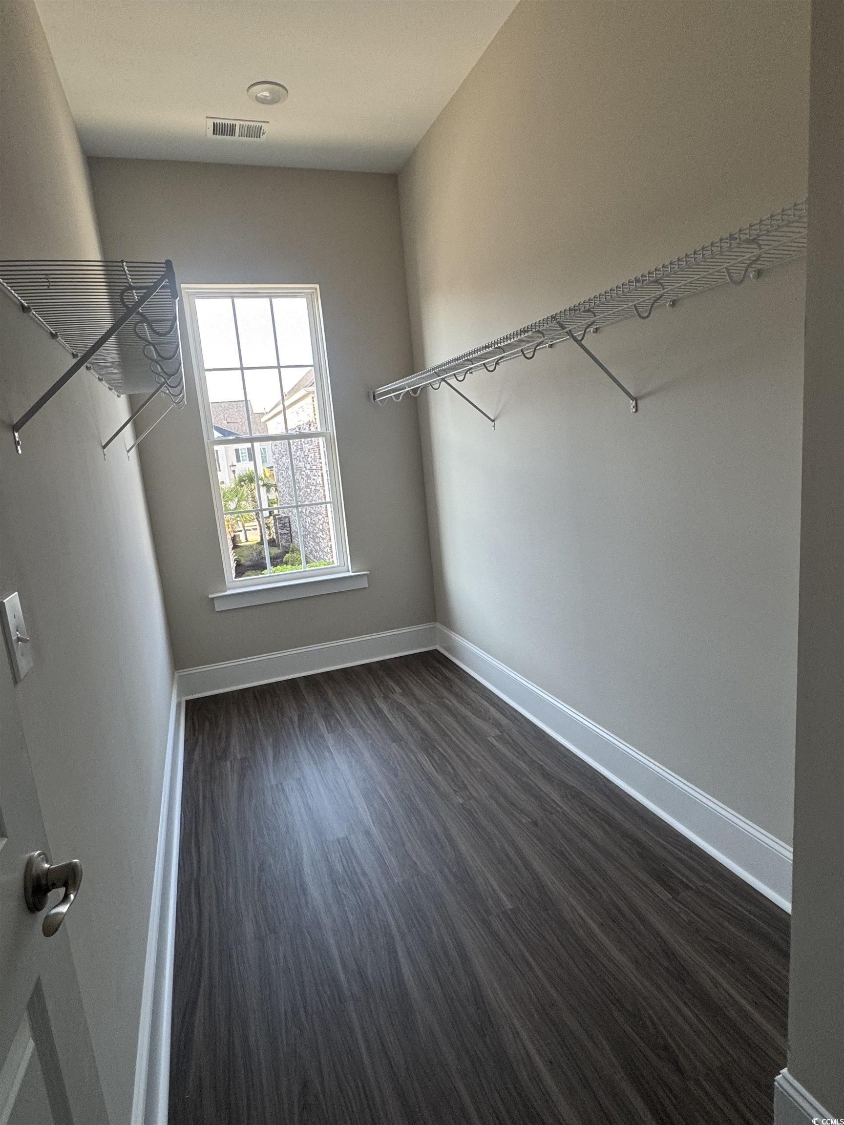 852 Iris Street, Unit D Myrtle Beach, SC 29577 - Photo 13 of 36 Spacious closet featuring dark wood finished floors