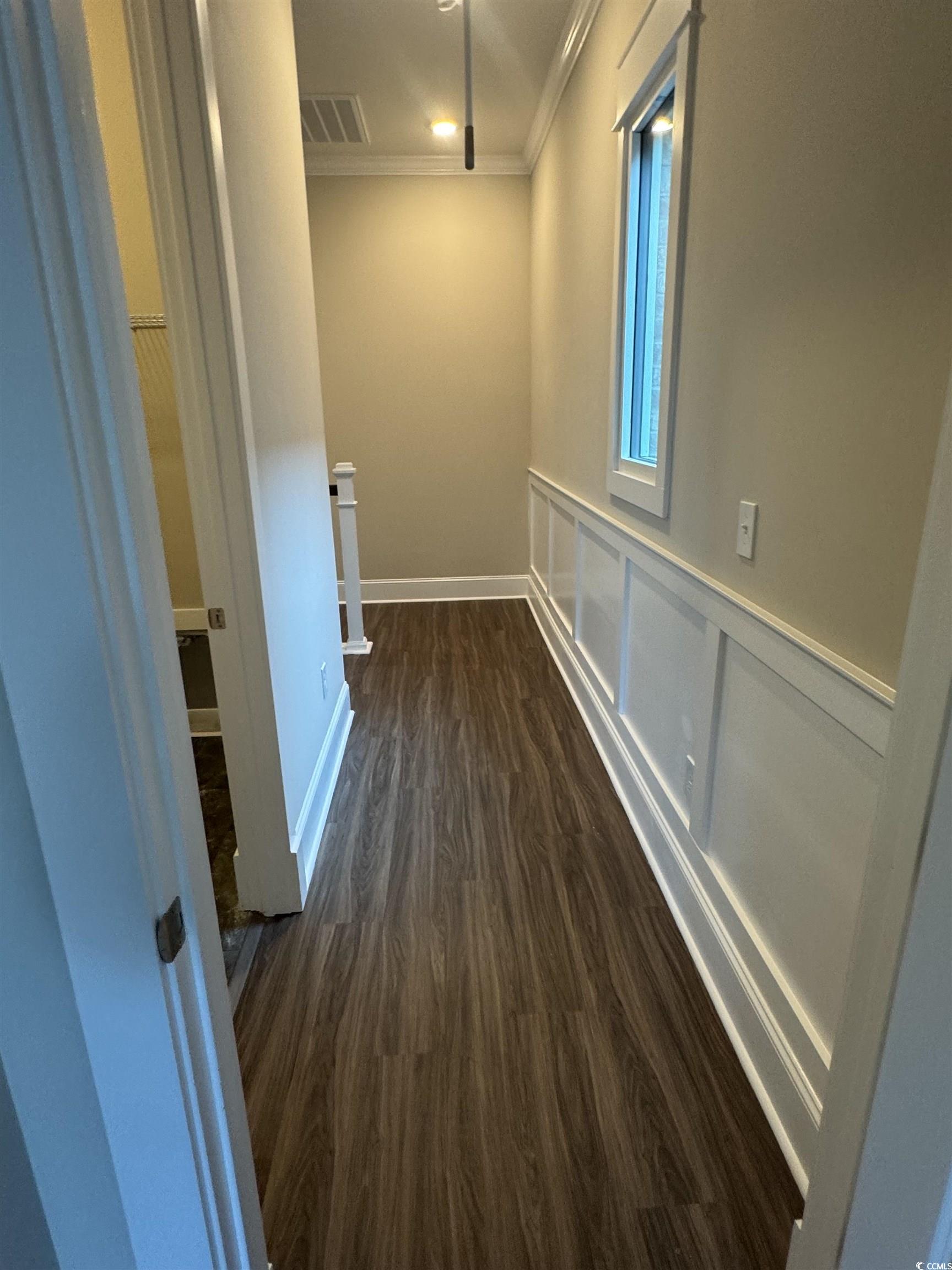 852 Iris Street, Unit D Myrtle Beach, SC 29577 - Photo 15 of 36 Hallway featuring crown molding and dark wood-style flooring