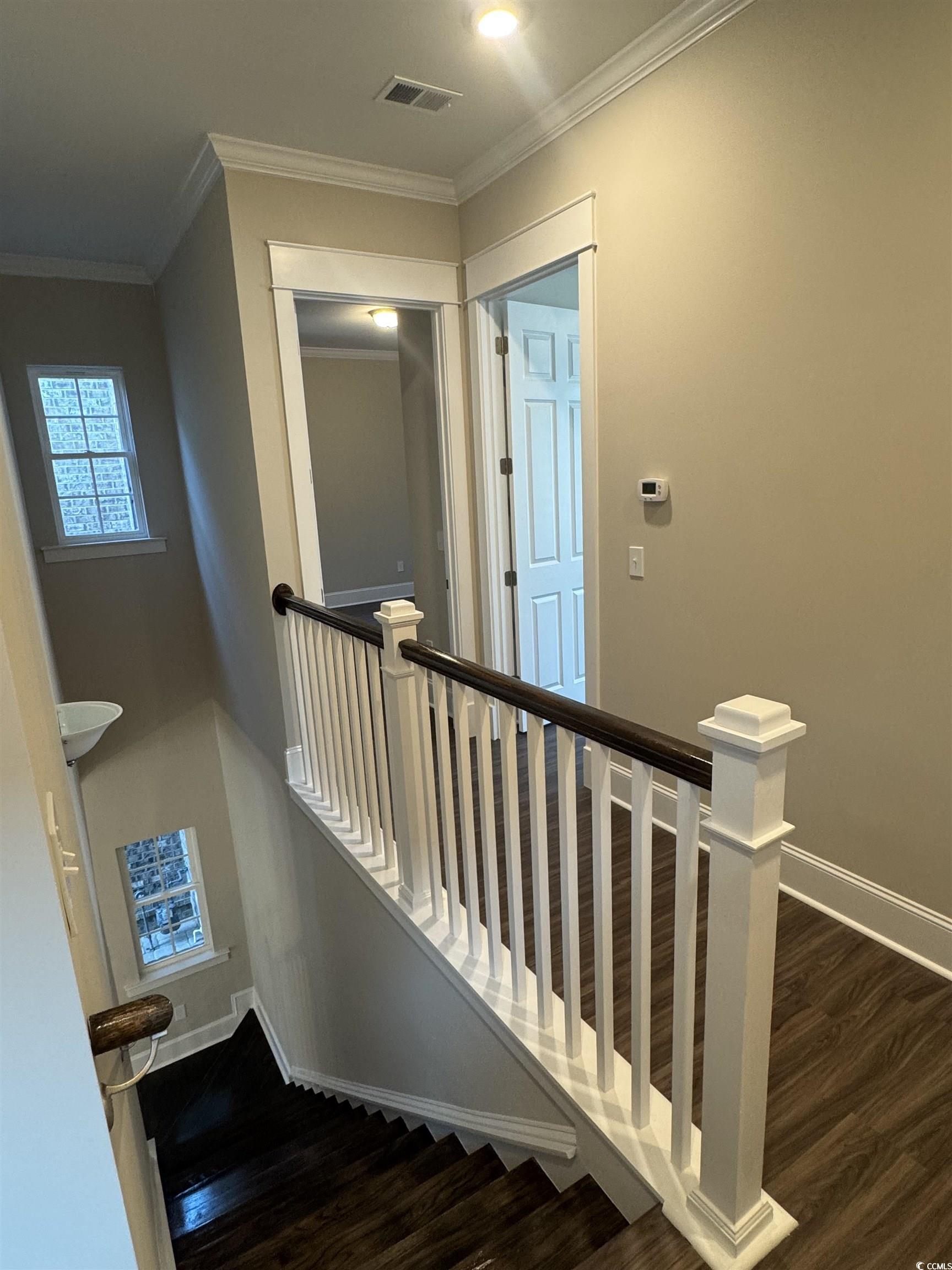 852 Iris Street, Unit D Myrtle Beach, SC 29577 - Photo 17 of 36 Staircase with wood finished floors and ornamental molding