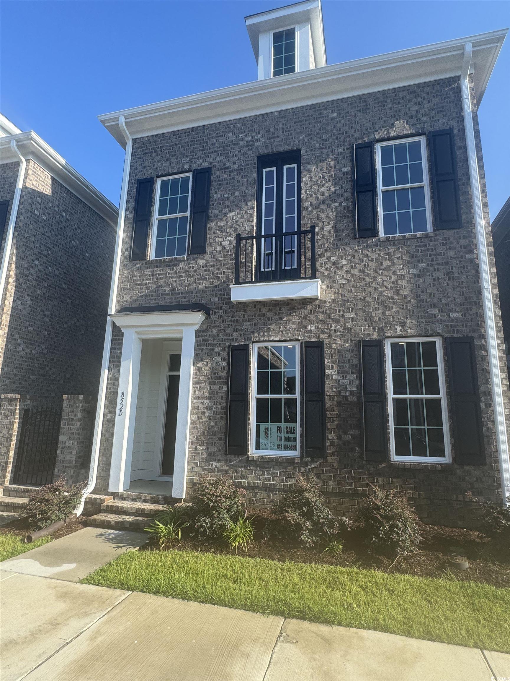 852 Iris Street, Unit D Myrtle Beach, SC 29577 - Photo 2 of 36 View of front of house with a balcony and brick siding