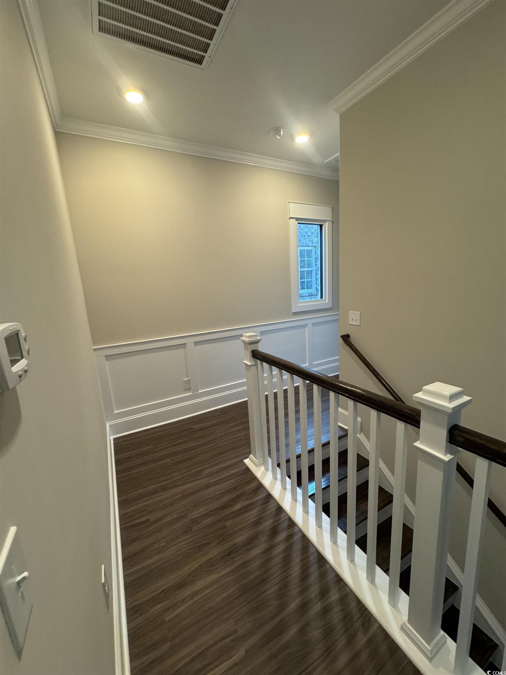 852 Iris Street, Unit D Myrtle Beach, SC 29577 - Photo 23 of 36 Corridor featuring an upstairs landing, wood finished floors, ornamental molding, wainscoting, and recessed lighting