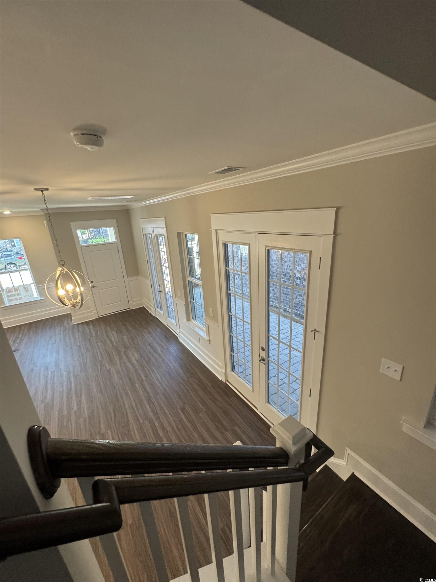 852 Iris Street, Unit D Myrtle Beach, SC 29577 - Photo 24 of 36 featuring ornamental molding, dark wood finished floors, and doors to access private Courtyard
