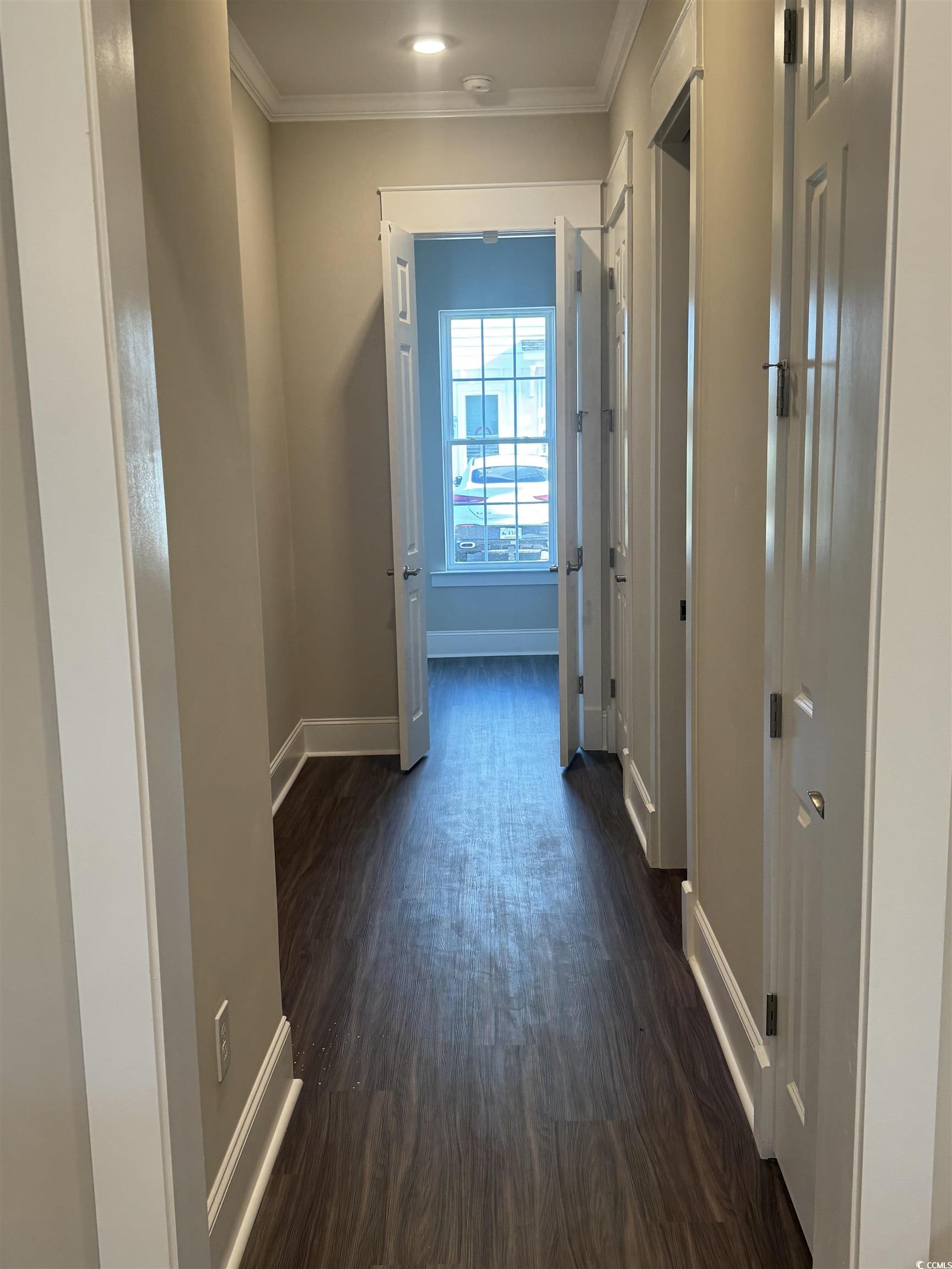 852 Iris Street, Unit D Myrtle Beach, SC 29577 - Photo 28 of 36 Corridor featuring crown molding and dark wood-style floors