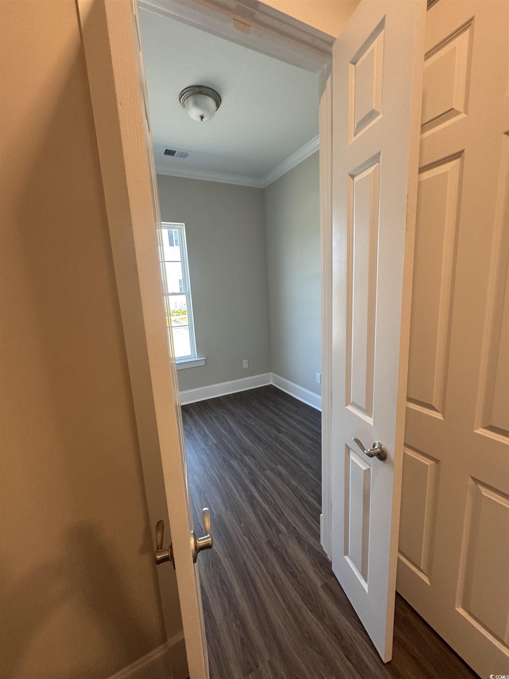 852 Iris Street, Unit D Myrtle Beach, SC 29577 - Photo 29 of 36 Hall featuring crown molding and dark wood-style flooring