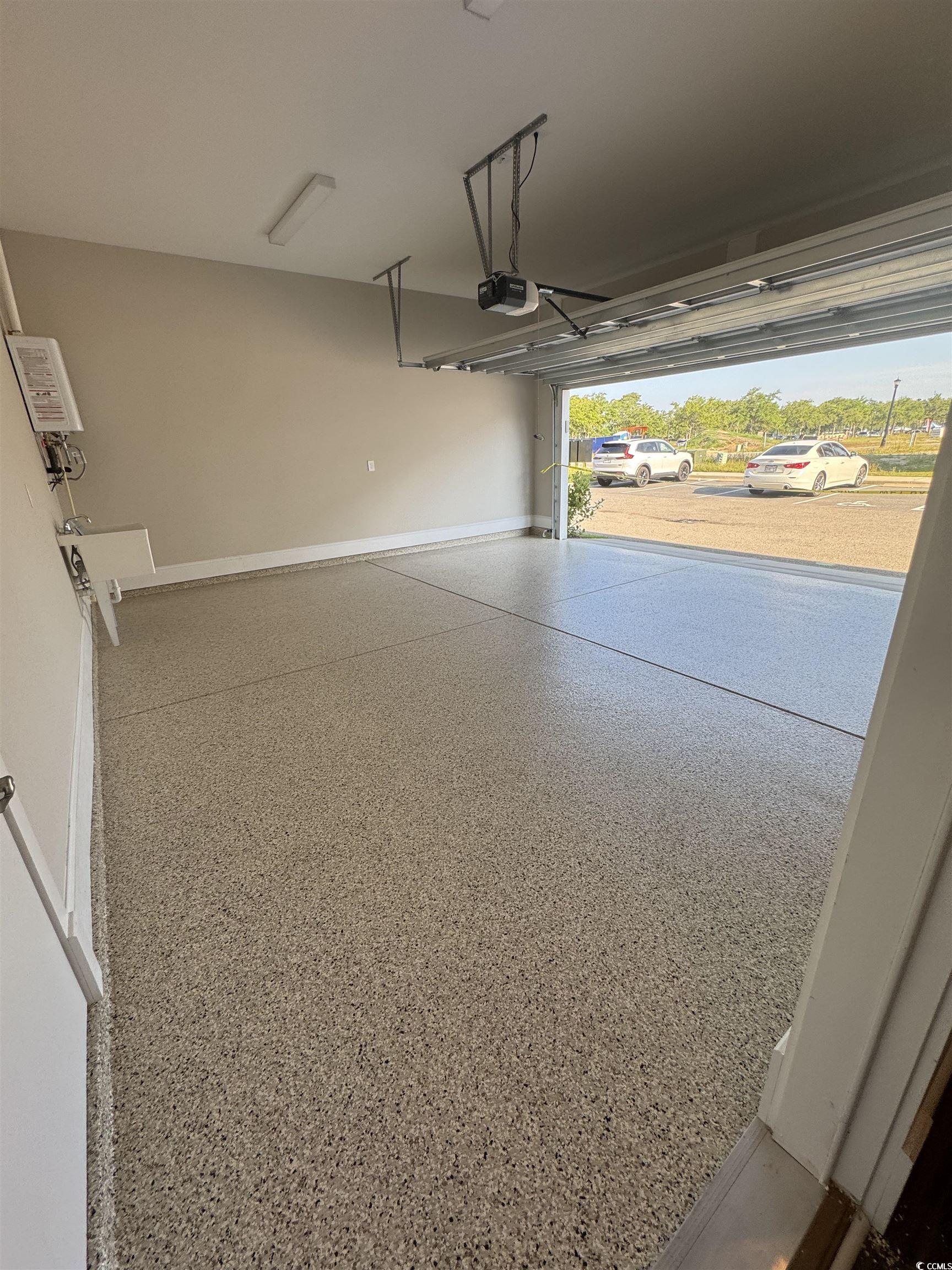 852 Iris Street, Unit D Myrtle Beach, SC 29577 - Photo 32 of 36 Garage with a garage door opener and baseboards