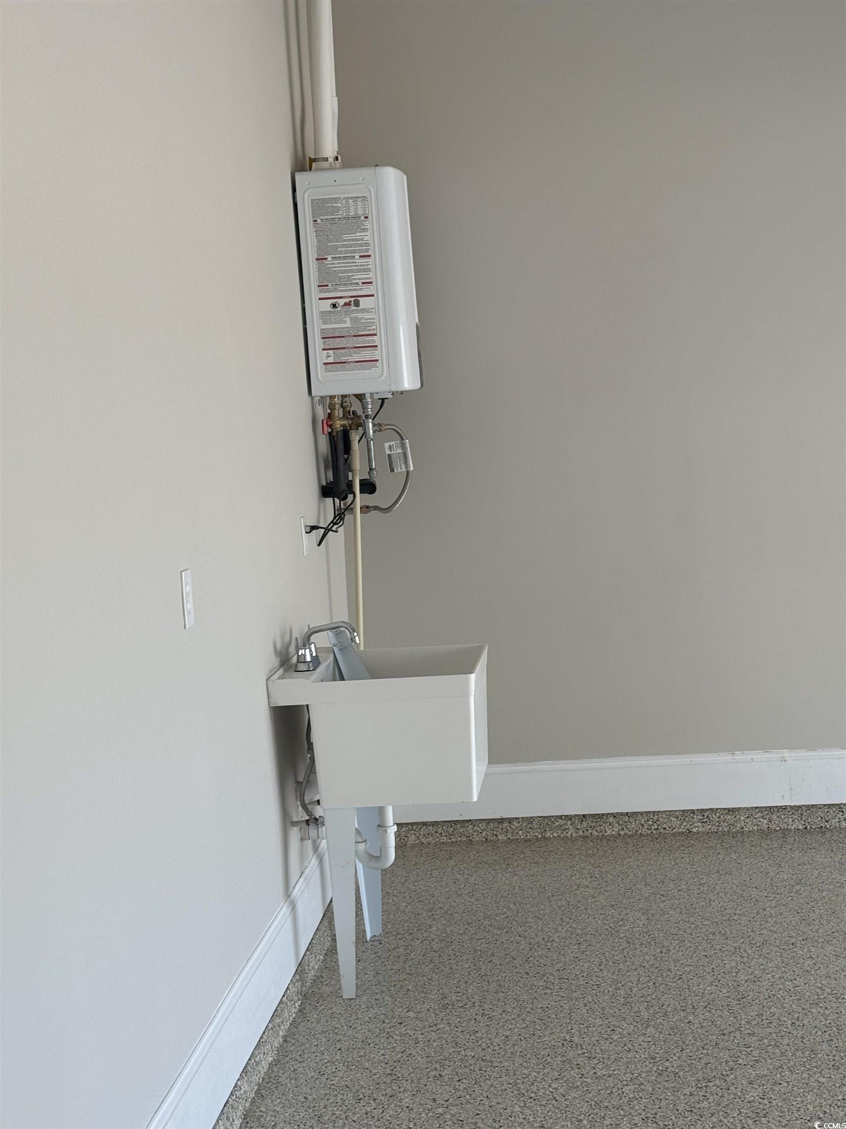 852 Iris Street, Unit D Myrtle Beach, SC 29577 - Photo 33 of 36 Detailed view of speckle patterned floor and water heater