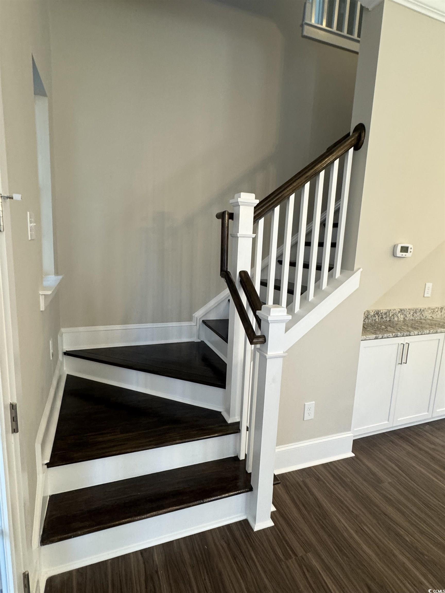 852 Iris Street, Unit D Myrtle Beach, SC 29577 - Photo 6 of 36 Stairs with wood finished floors and baseboards