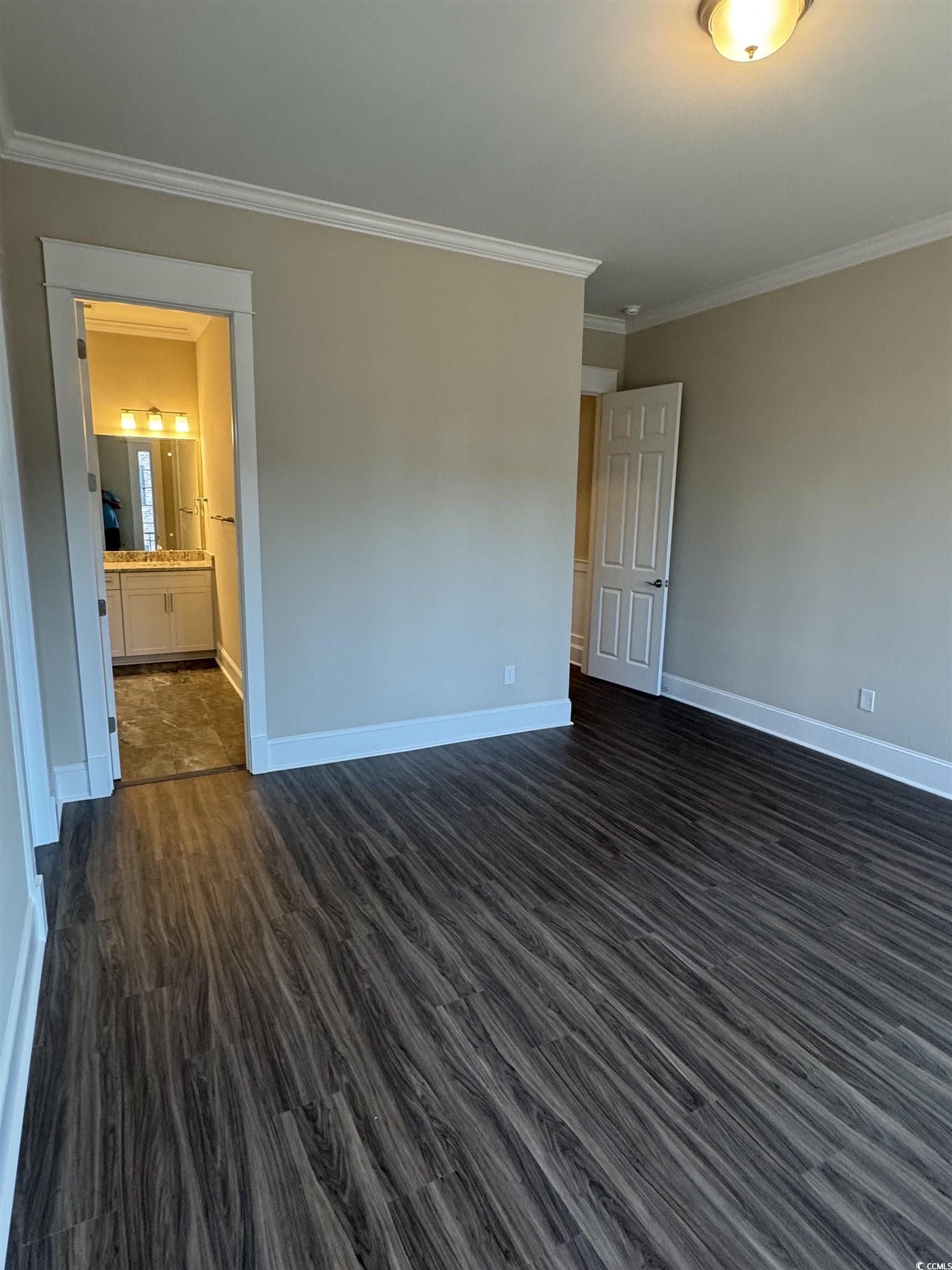 852 Iris Street, Unit D Myrtle Beach, SC 29577 - Photo 8 of 36 Spare room featuring crown molding and dark wood finished floors