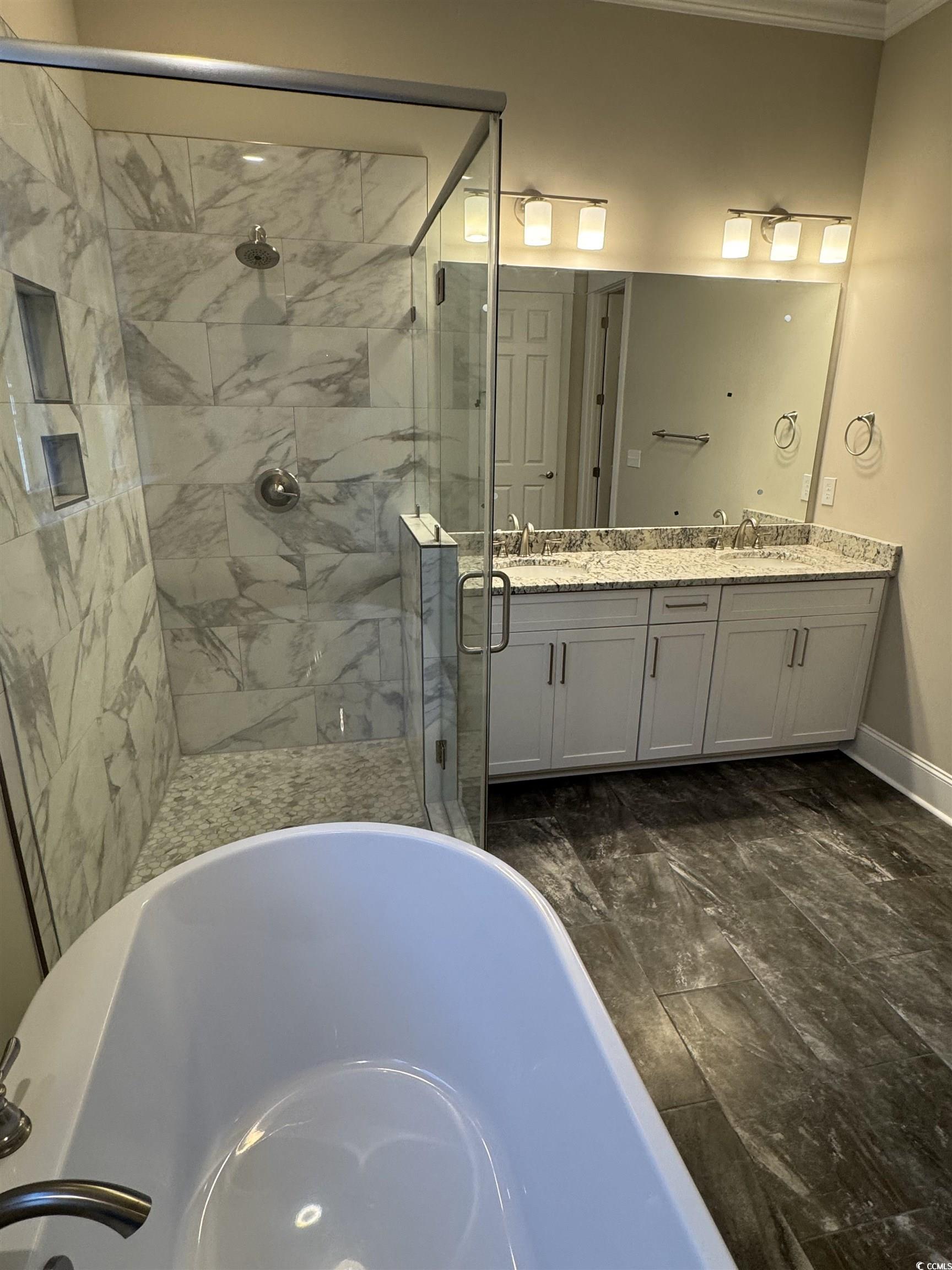 852 Iris Street, Unit D Myrtle Beach, SC 29577 - Photo 10 of 36 Full bath with a soaking tub, a shower stall, ornamental molding, double vanity, and marble finish floors