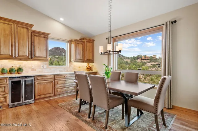 a dining room with furniture a chandelier and wooden floor