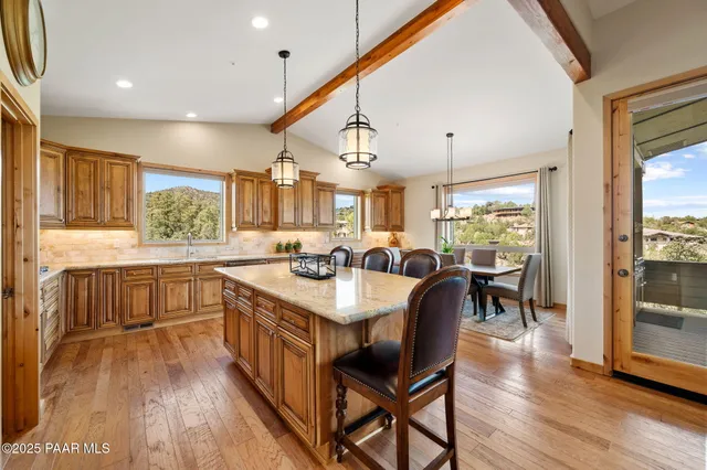 a large kitchen with a table and chairs