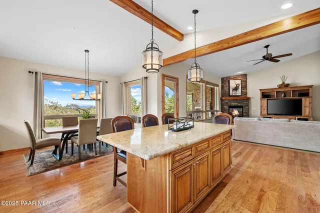 a kitchen with a table chairs and wooden floor