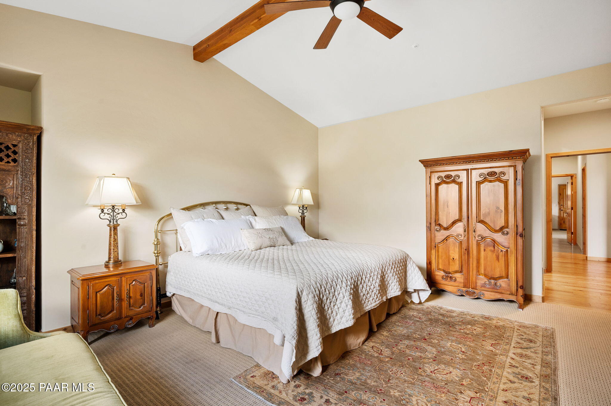 2214 Lichen Ridge Lane Prescott, AZ 86303 - Photo 22 of 46 a bedroom with a bed a lamp on dresser and a chandelier