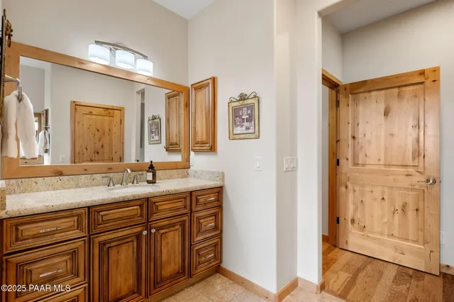 a bathroom with a granite countertop sink mirror and