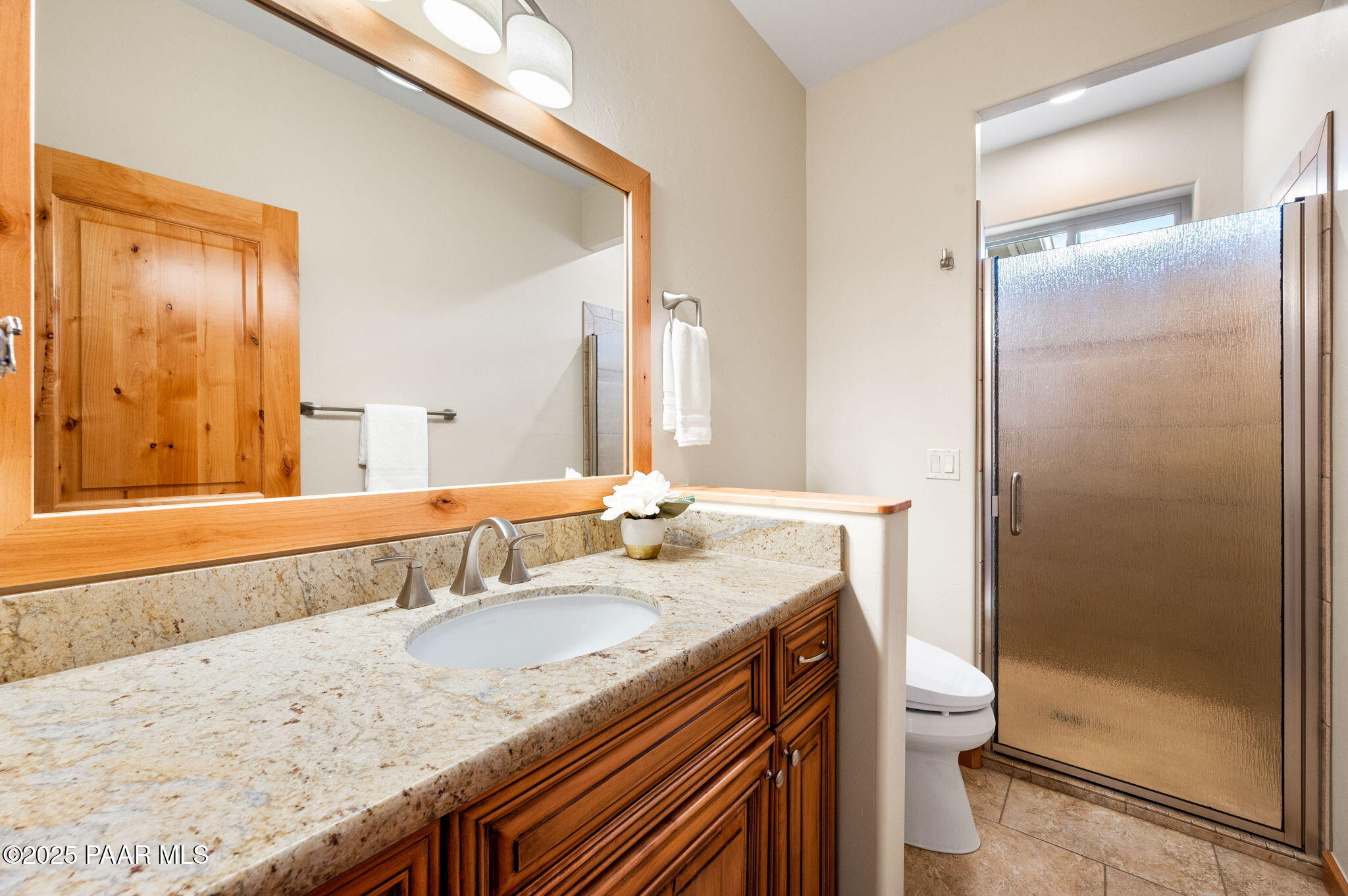 2214 Lichen Ridge Lane Prescott, AZ 86303 - Photo 30 of 46 a bathroom with a granite countertop sink a toilet and shower
