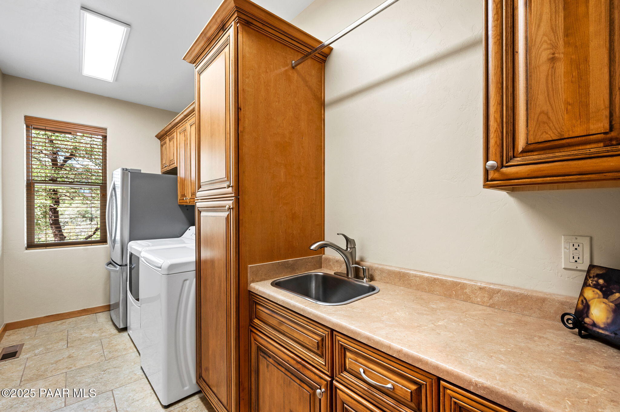 2214 Lichen Ridge Lane Prescott, AZ 86303 - Photo 33 of 46 a kitchen with a sink and a refrigerator