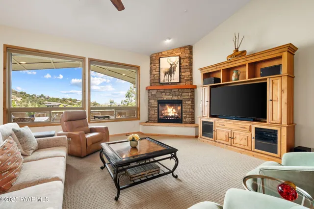 a living room with furniture fireplace and flat screen tv