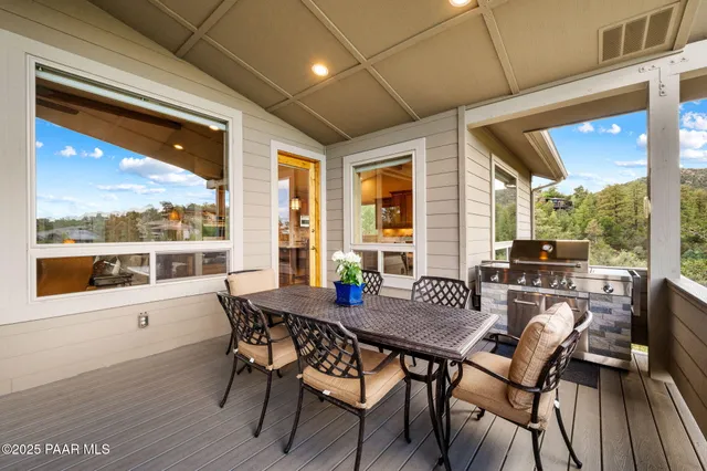 a view of a dining room with furniture large windows and wooden floor
