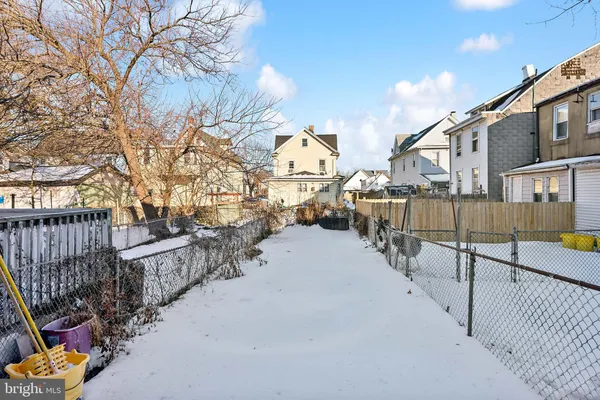 a view of a street with wooden fence