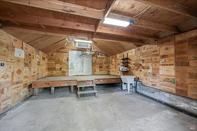 a kitchen with a stove and wooden floor