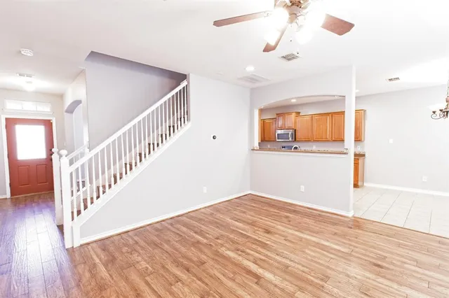 a view of a room with wooden floor and staircase