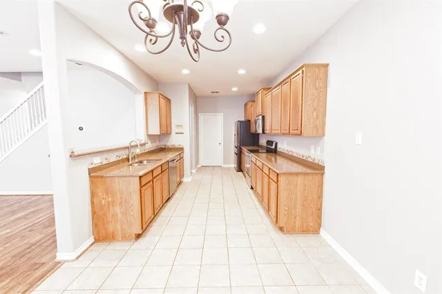 a kitchen with a refrigerator and a sink