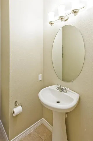 a bathroom with a sink a mirror and a toilet