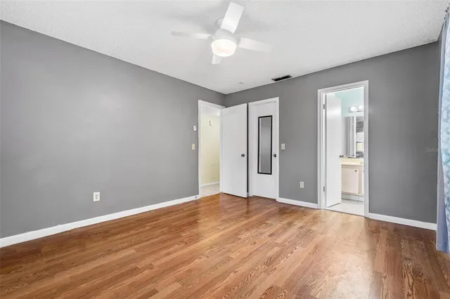 a view of an empty room with wooden floor