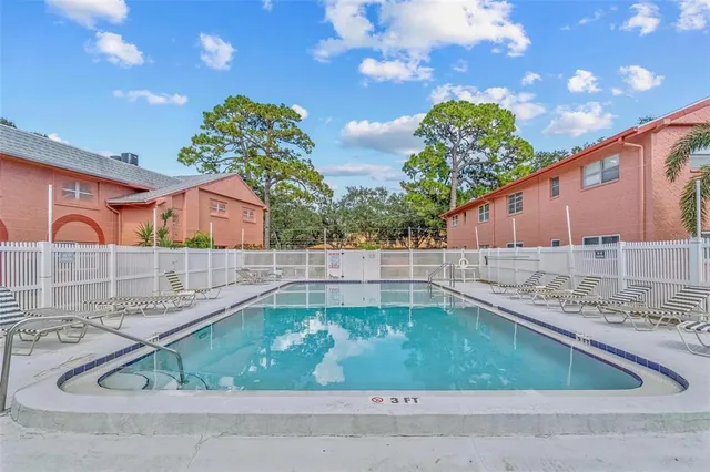 a view of backyard with swimming pool and outdoor seating