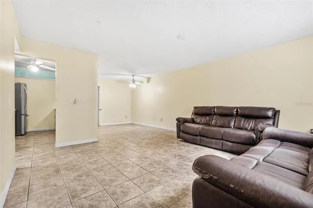 a living room with furniture and a glass door shower