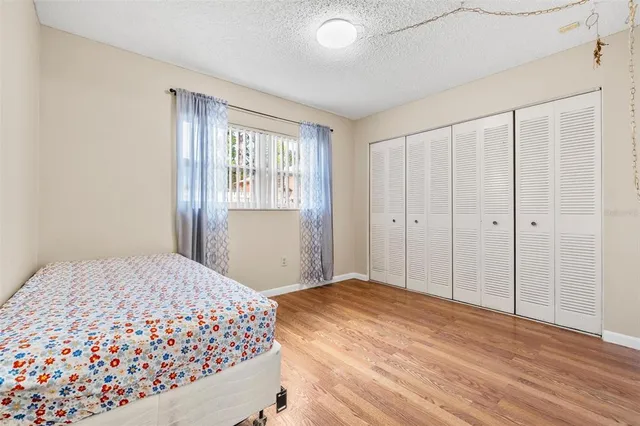 a bedroom with a large bed and a window