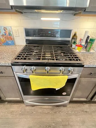 a stove top oven sitting inside of a kitchen