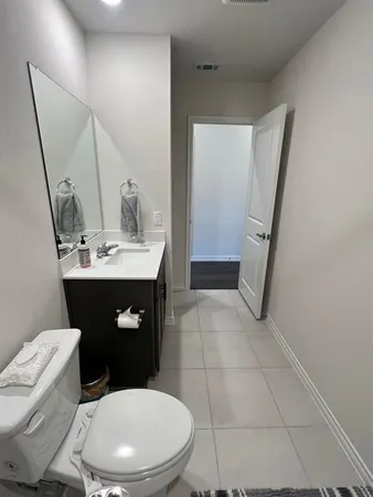 a bathroom with a toilet a sink and mirror