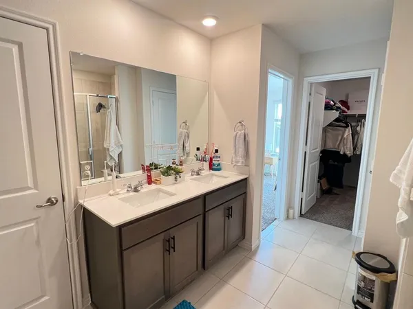 a bathroom with a sink a toilet and mirror