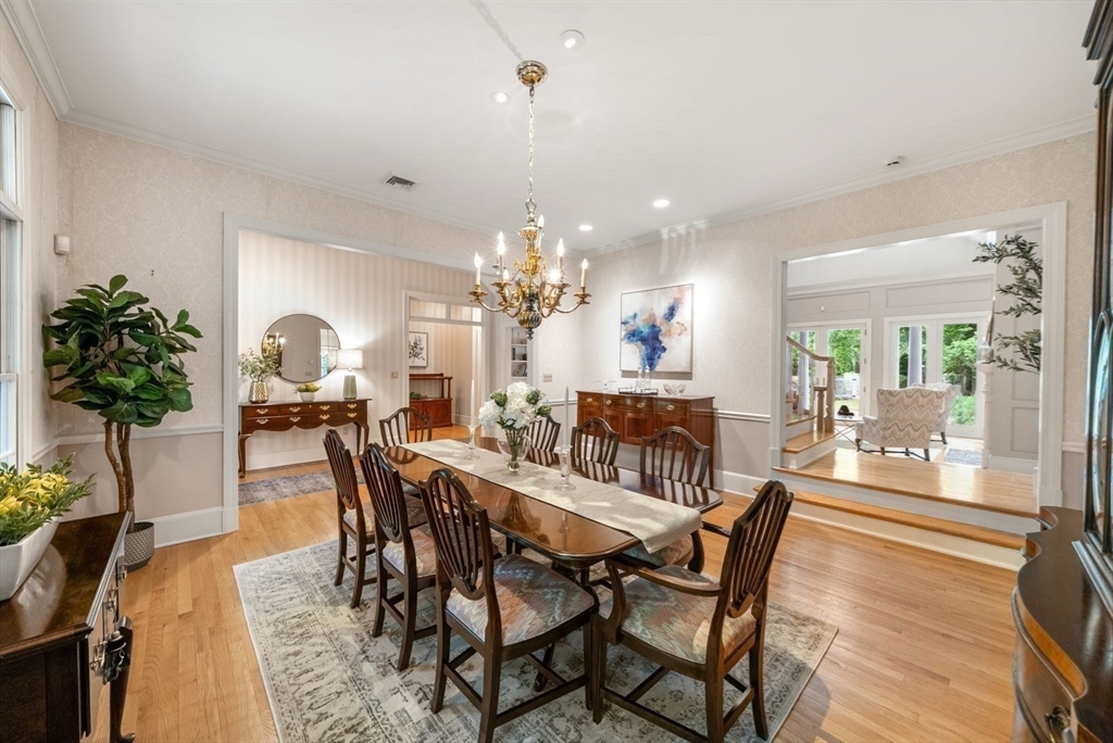 364 Hickory Road North Attleboro, MA 02760 - Photo 9 of 40 a view of a dining room and livingroom with furniture wooden floor a chandelier