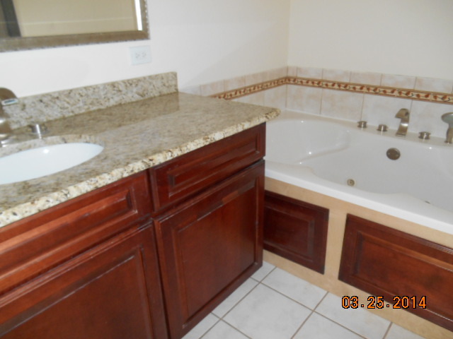 9 Edgewood Road Vernon Hills, IL 60061 - Photo 13 of 13 a bathroom with a granite countertop sink and a mirror