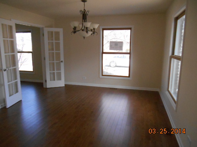 9 Edgewood Road Vernon Hills, IL 60061 - Photo 2 of 13 an empty room with wooden floor and windows