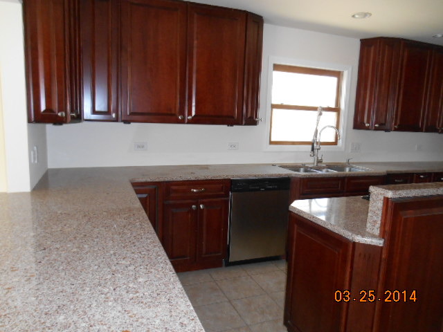 9 Edgewood Road Vernon Hills, IL 60061 - Photo 6 of 13 a kitchen with granite countertop cabinets sink and window