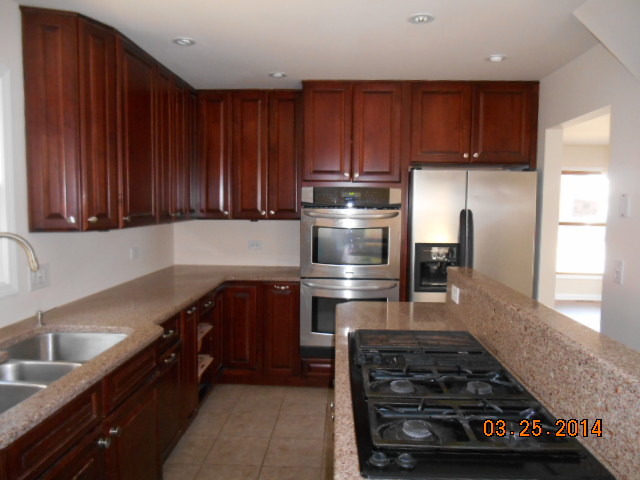 9 Edgewood Road Vernon Hills, IL 60061 - Photo 7 of 13 a kitchen with wooden cabinets and a stove top oven